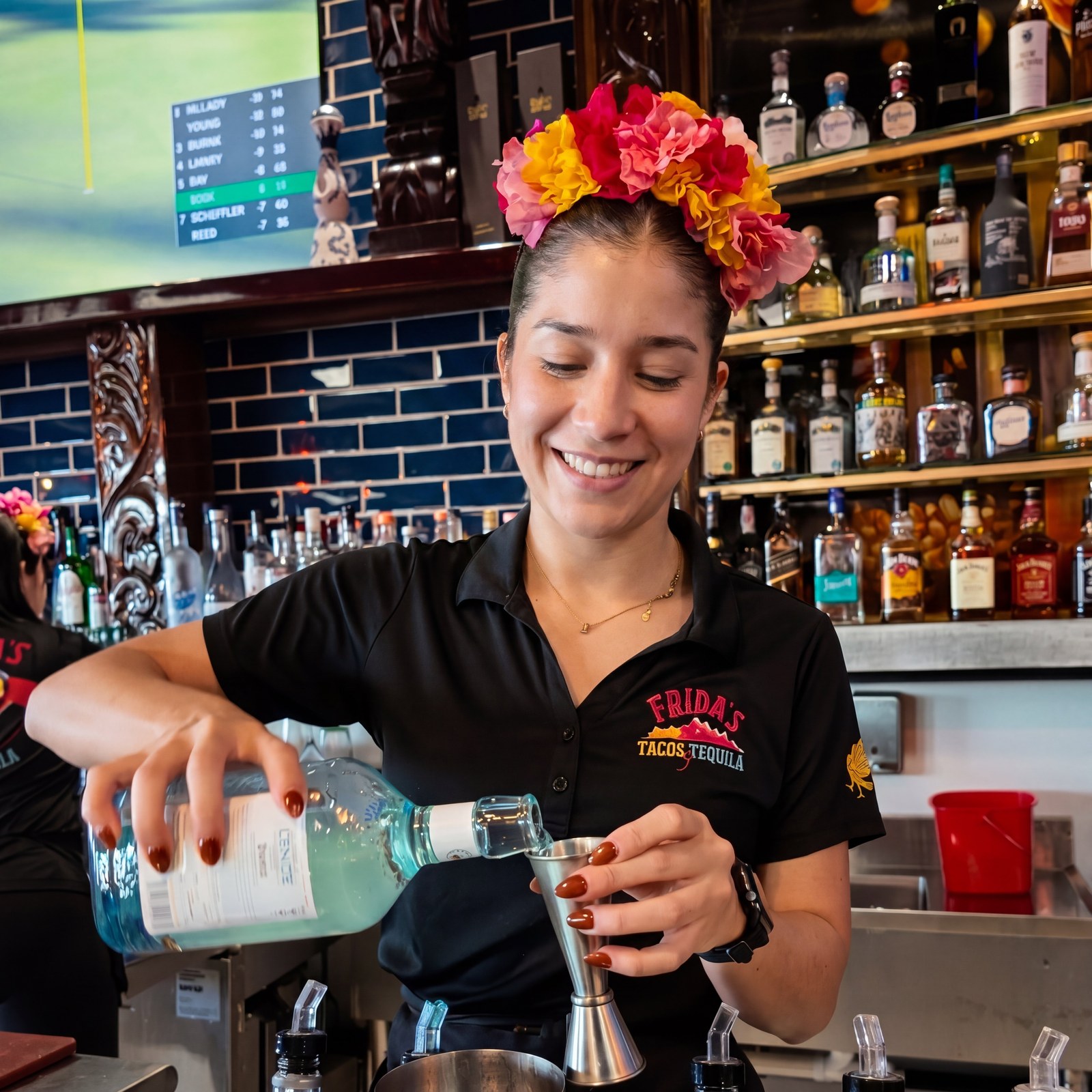 Frida's bartender pouring premium tequila